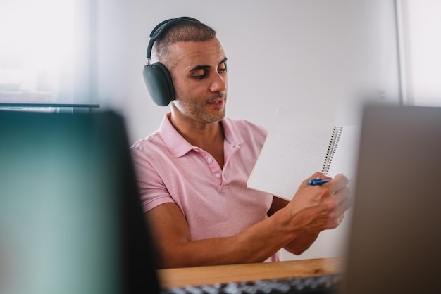 Focused business man entrepreneur with laptop and headphones Male professional using computer