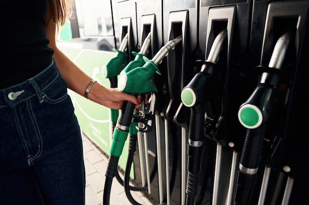 Focused detailed close up view Young woman on the gas station