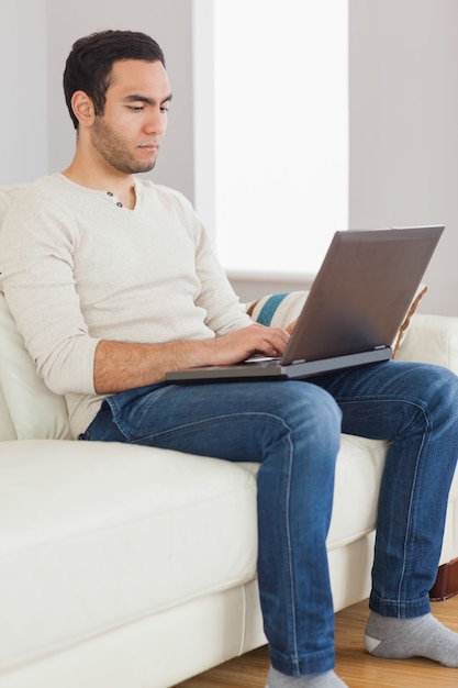 Focused handsome man using his tablet computer