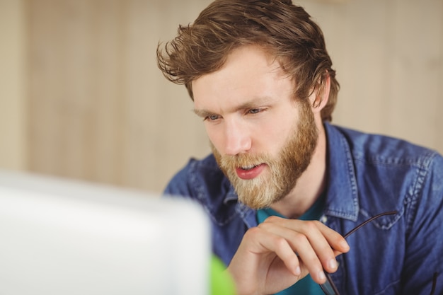 Focused hipster working at his desk