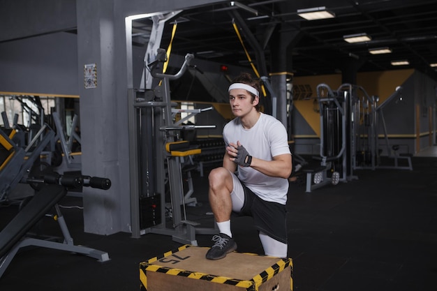 Focused male athlete exercising on jumping box