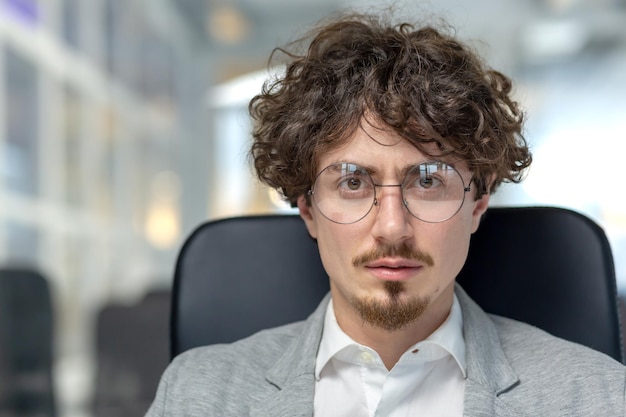 Focused male office worker at his workplace exudes confidence displays traits like dedication