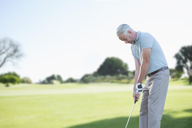 Focused man doing golf