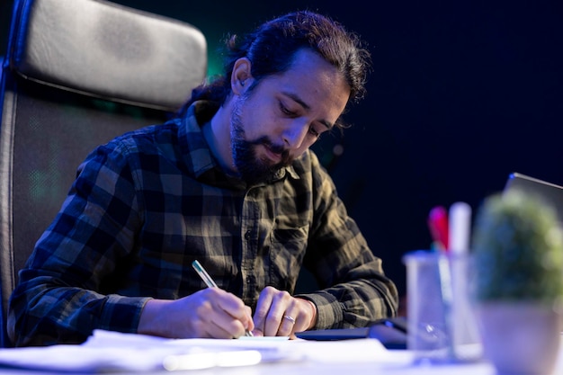 Focused man writing in notebook