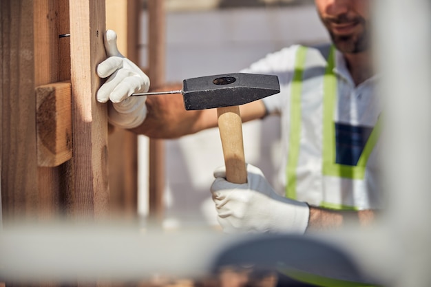 Focused photo on hammer being in strong hand