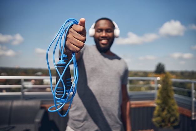 Focused photo on male hand that holding skippingrope