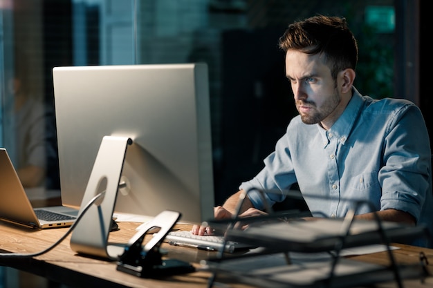 Focusing man working with computer in office