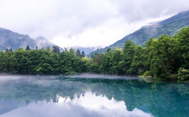 Fog creeps over the water of Lower Blue Lake, Kabardino-Balkaria Republic,Russia