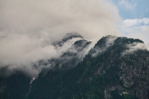 Fog in the mountain valley. Morning fog over the lake in the Altai mountains.