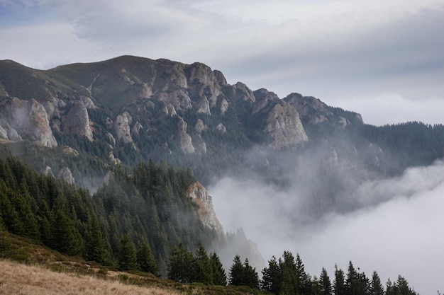 Fog and mountains landscape in Ciucas mountains of Romania