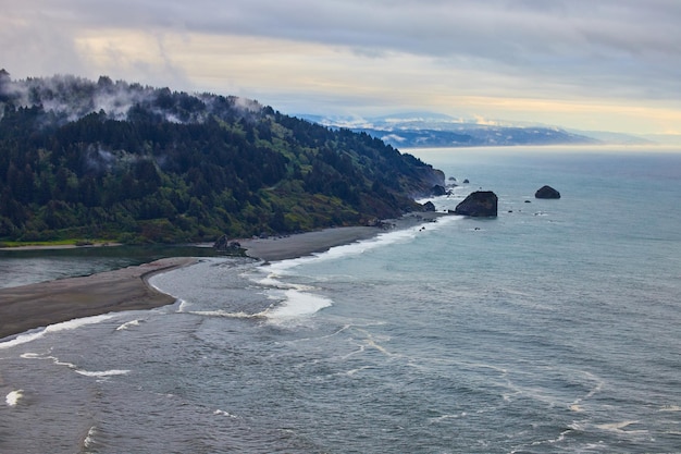 Foggy morning on the beach from above with soft colors