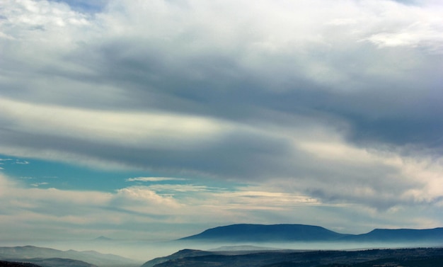 Foggy mountain and clouds in the sky