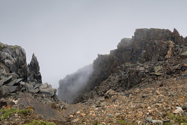 Foggy mountain view from cliff at very high altitude Scenic alp