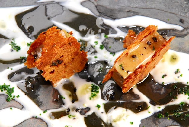 foie gras appetizer with toasted wafers and toppings stone plate tile slate wooden table food