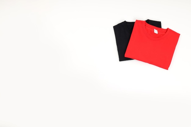 Folded black and red t-shirts isolated on white background