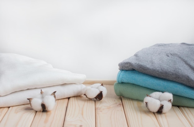 Folded clothes in a pile of cotton On a wooden background