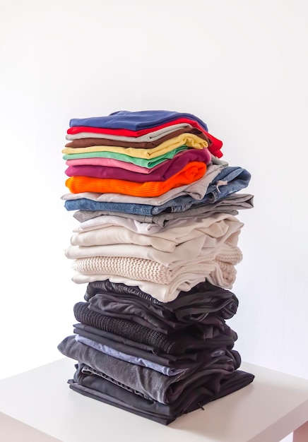 Folded colorful clothes in stack Home organizing Domestic storage