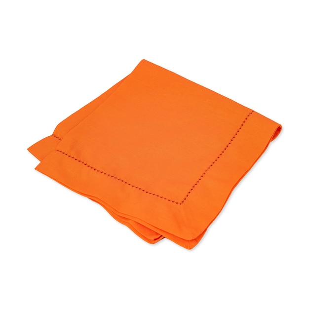 Folded orange tissue napkin isolated over white background