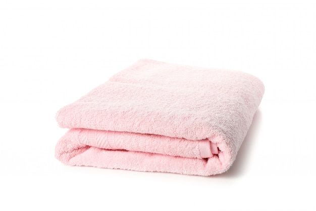 Folded pink towel isolated on white, close up