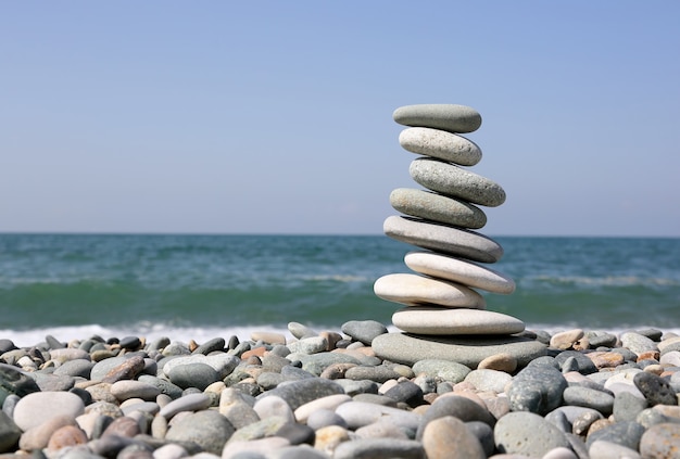 Folded pyramid of smooth stones on the seashore
