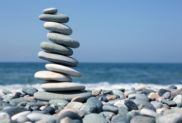 Folded pyramid of smooth stones on the seashore