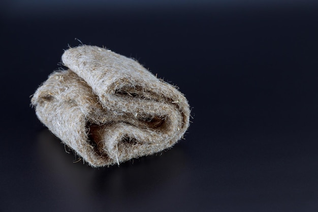 Folded rug on a black background for sowing microgreens