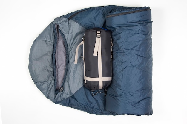 Folded sleeping bag on a white surface. items for tourism and camping