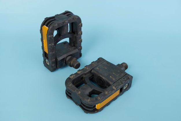 Folding bicycle pedals part of a folding bicycle isolated on blue background