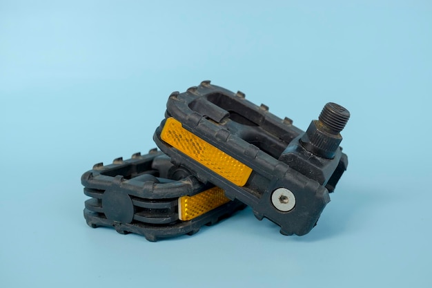 Folding bicycle pedals part of a folding bicycle isolated on blue background