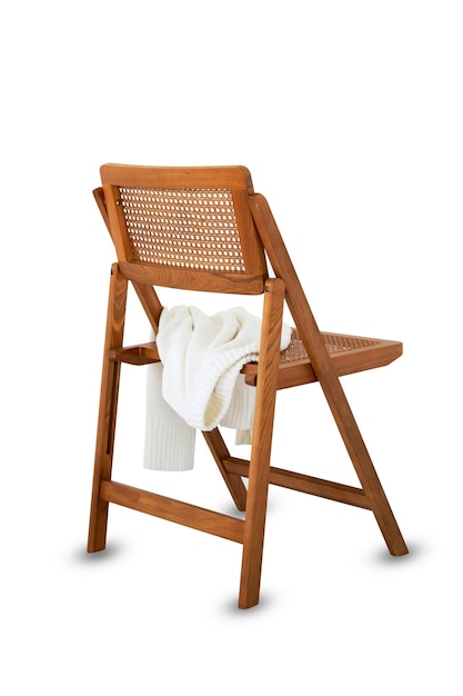 Folding wooden chair with a winter Tshirt on its seat white background