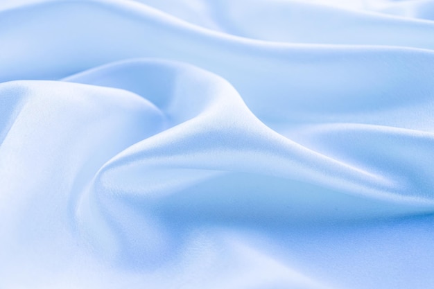 folds of sky blue fabric background, space for text