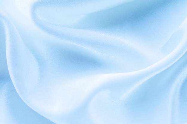 folds of sky blue silk fabric texture background