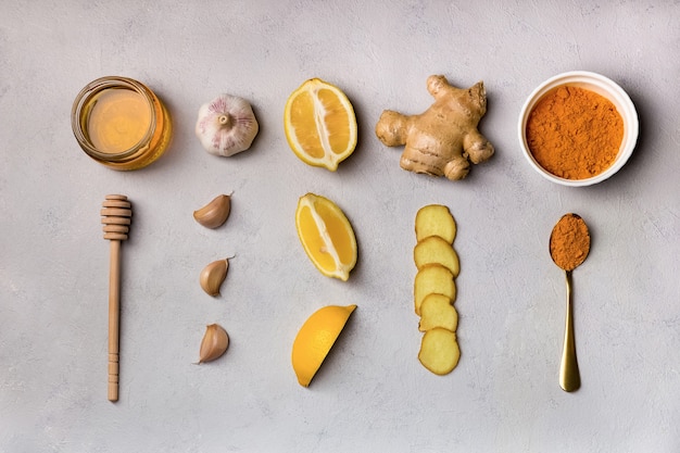 Folk remedies ginger, garlic, turmeric, honey, lemon ingridients for making drinks, top view.