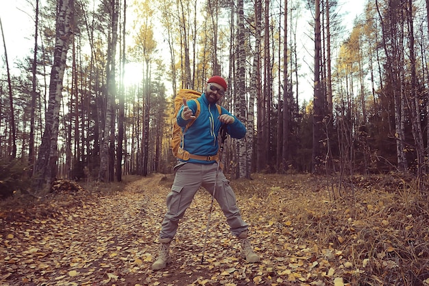 follow me on a hike, a man invites you to a forest hike, autumn landscape in the forest in nature