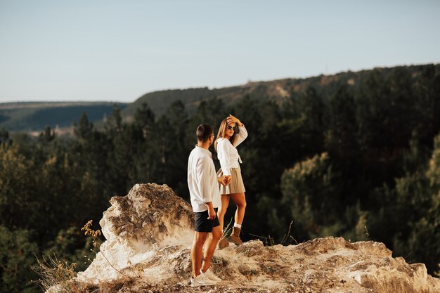 Follow me, young couple on a walk on the mountains