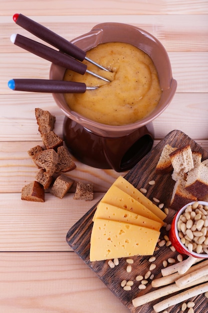 Fondue biscuits spices and rusks on bamboo plate on wooden background