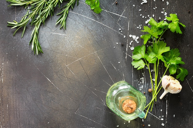 Food background Parsley and rosemary on a dark stone table Copy space