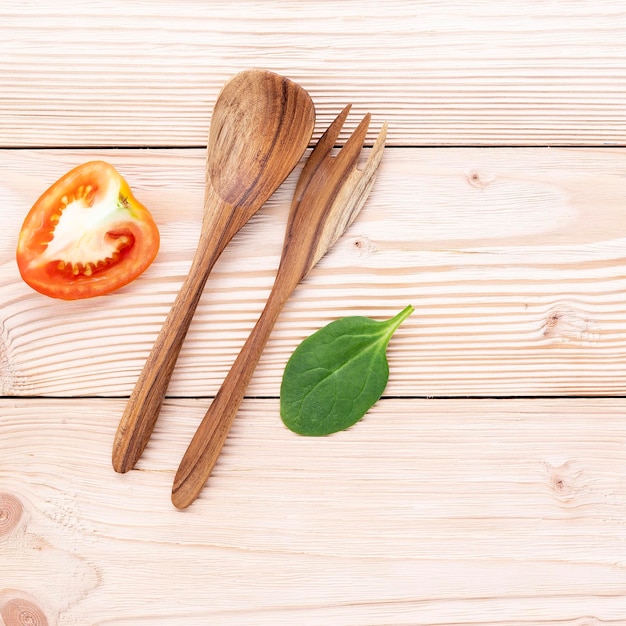 Food background and salad concept with raw ingredients flat lay on white wooden background