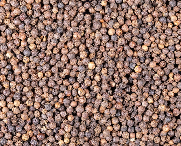 Food backgroundBlack pepper granules close upFlat lay