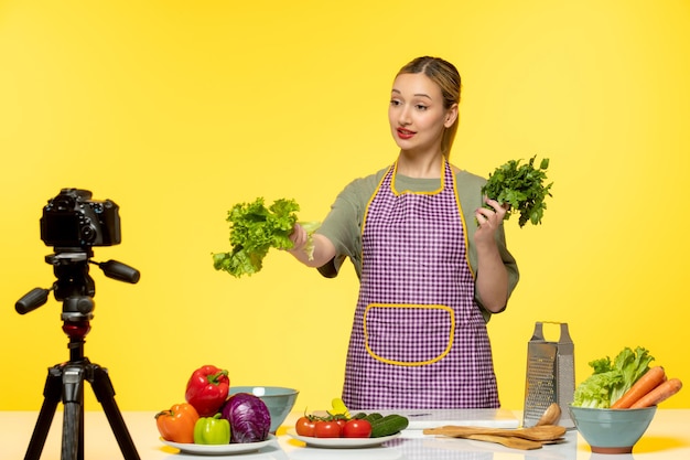 Food blogger adorable healthy chef recording video for social media giving a parsley