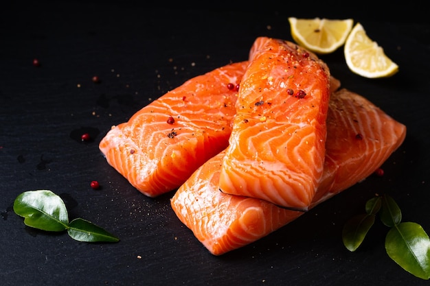 Food concept Uncook fresh salmon on black slate stone board with copy space