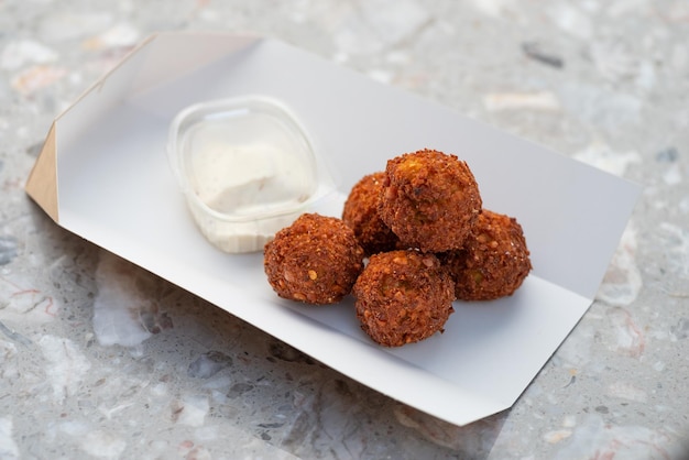 Food delivery falafel takeaway food paper containers with falafel balls and sauce