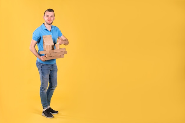 Food delivery young man in a blue t-shirt