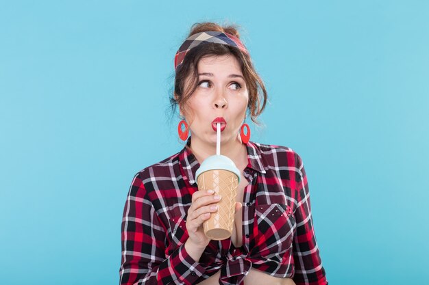 Food diet and fun concept  woman in pinup style with glass of coffee