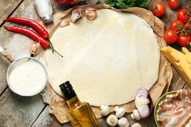 Food ingredients for pizza on table close up