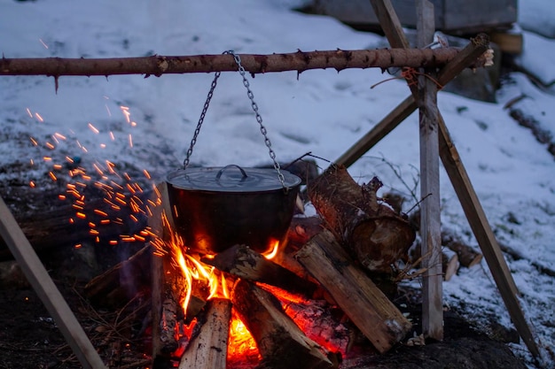 Food is prepared in a cauldron on an open fire rest in the evening in nature