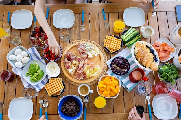 food and peoples handsPeople have breakfast at the table top viewBreakfast for the familyDinner