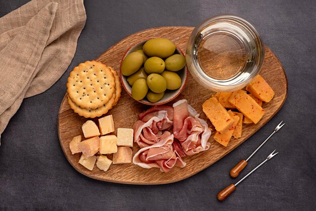 Food photography of antipasto white wine cheese ham serrano olive prosciutto parmesan cheddar