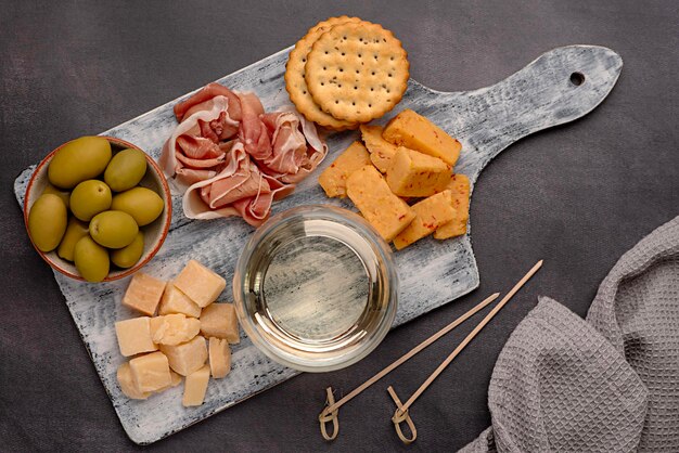 Food photography of antipasto white wine cheese ham serrano olive prosciutto parmesan cheddar