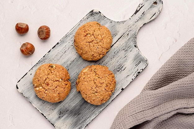 Food photography of oat biscuit oatmeal cookienut hazelnut pastry dessert wooden board